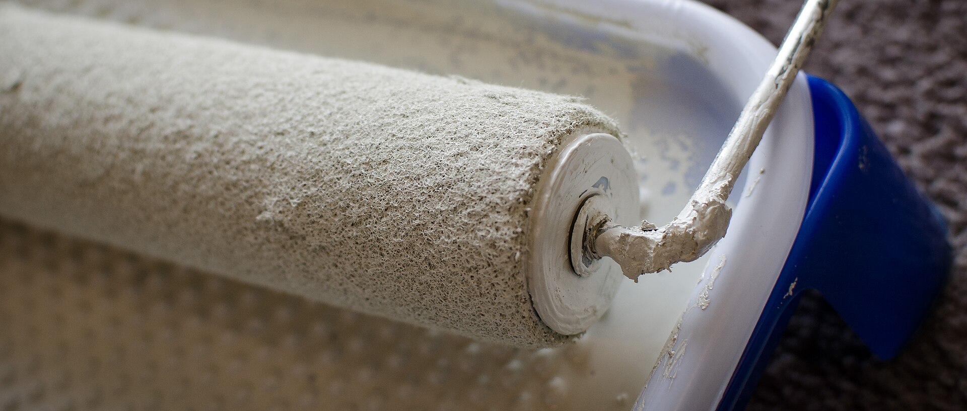 A paint roller loaded with paint